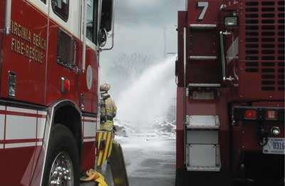 (10) With a Virginia Beach engine as the water supply, a Navy ARFF applies foam to the tail section from the 24th Street Division.