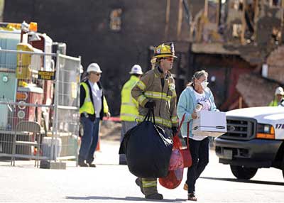 (14) Residents were assigned a firefighter to assist with retrieving personal items. [Photo by Tim Riley, Virginia Beach (VA) Fire Department.]