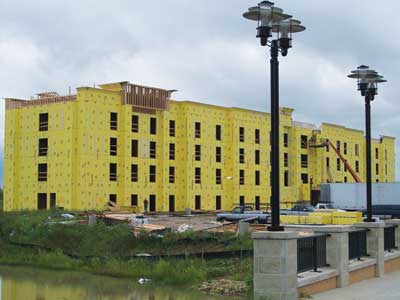 (3) Today's lightweight wood frame structures include large commercial buildings, such as this hotel, which can be enormous and include huge unsprinklered void spaces and potentially include huge unsprinklered void spaces. The entire structure is being wrapped in synthetic foam insulation. (Photo by author.)