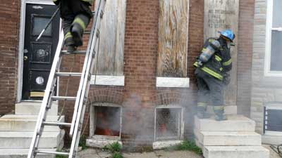 (16) Firefighters do not delay in initiating the primary duties of the first-arriving truck company. (Photo by Nick Eid.)