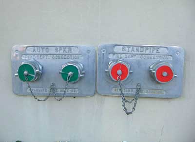 (3) This old high-rise building has separate sprinkler and standpipe systems. The plugs for the sprinkler system fire department connection (FDC) are green; the plugs for the standpipe FDC are red.