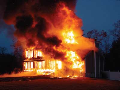 (4) Large, uninterrupted void spaces in modular homes can allow rapid fire spread, as in this fire. In just a few minutes, this occupied structure was fully involved; occupants narrowly escaped and were unharmed. [Photo courtesy of Acushnet (MA) Fire Department.]