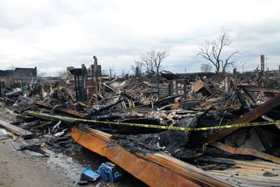 (2) The conflagration in Rockaway Park, New York. At Beach 114th to Beach 115th Street and Rockaway Beach Boulevard, three blocks of stores and commercial buildings were destroyed. The firehouse is only a few blocks away, but the storm surge created chest-high water levels, making it impossible to fight the fires. 