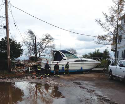 (6) Fire Department of New York units searching for possible survivors in Staten Island houses the day after the storm. 