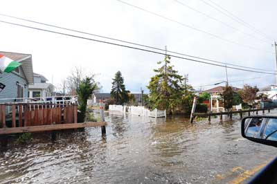 (1) Water was still present in the streets on the west end of the Rockaway Peninsula two full days after Sandy's surge. At the height of the surge, this street was under almost seven feet of water. (Photos courtesy of the Fire Department of New York.)