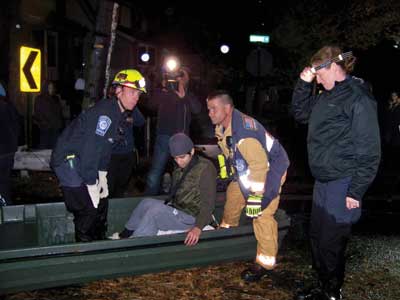 (3) VA-TF1 personnel aided New Jersey rescue personnel in rescuing stranded victims within a block of the Little Ferry command post, depositing them on dry ground. No personal flotation devices were required since the water was only knee-deep at this point. [Photos courtesy of the Federal Emergency Management Agency (FEMA).]