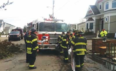 (4) BC/TF-1 at a Toms River car fire overhauling the vehicle near a building. (Photo by Richard Quinton Jr.)