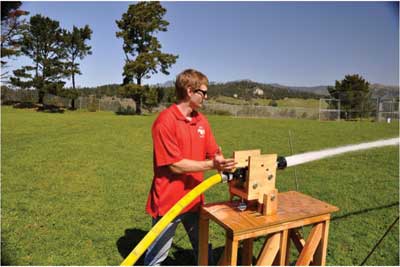 (2) A California Polytechnic State University fire protection engineering student conducts a test on nozzle forces that a firefighter would experience. (Photo by D.R. Turner.)