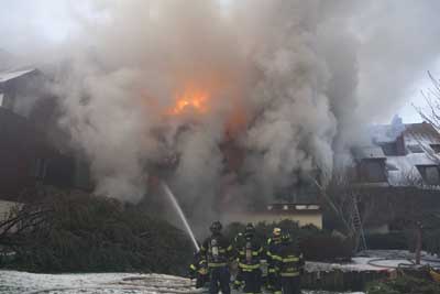 (6) The conditions on the Charlie side of the fire (inside the horseshoe) were much smokier, as it was leeward of the fire. Access to individual units in this area was also difficult. Note the division commander-a critical piece of fireground command, control, and information. (Photo by Ron Jeffers.)