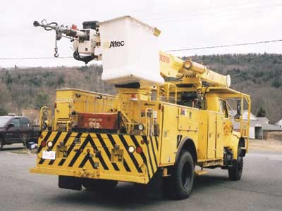 60-foot Altec 4 × 4 bucket truck features a large 2½-inch nozzle fed by a 2½-inch line, a heavy-duty winch for rescue work, and a breathing air line