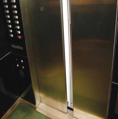 Elevator doors unable to close as a result of the winter stack effect-air rushing into the shaft from the lobby entrances. The doors will have to be forcefully closed by firefighters to begin Phase 2 operation. Lobby doorways must be closely controlled and supervised.