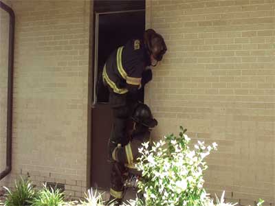 When working in pairs, using the knee of one firefighter will allow the other firefighter to enter the window with a tool already in hand.