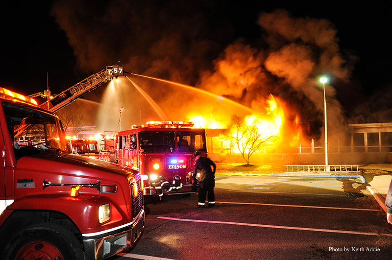 Fire streams are directed on a fire at an Edison (NJ) elementary school. Photo by Keith Addie.