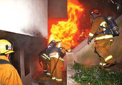 The second hoseline is flaked out for an advance into the fire floor while the first hoseline is being placed on the floor above.