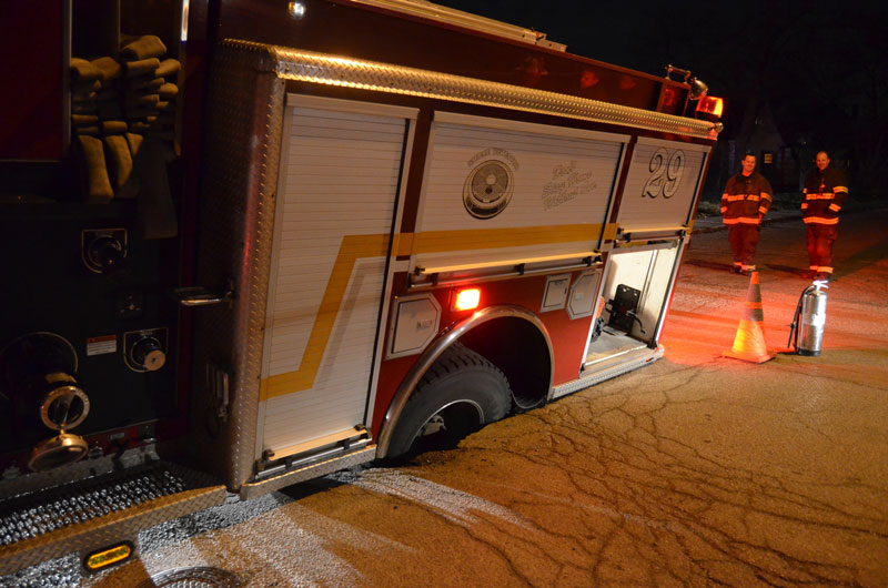 An Indianapolis Fire Department fire apparatus became caught in a sinkhole.