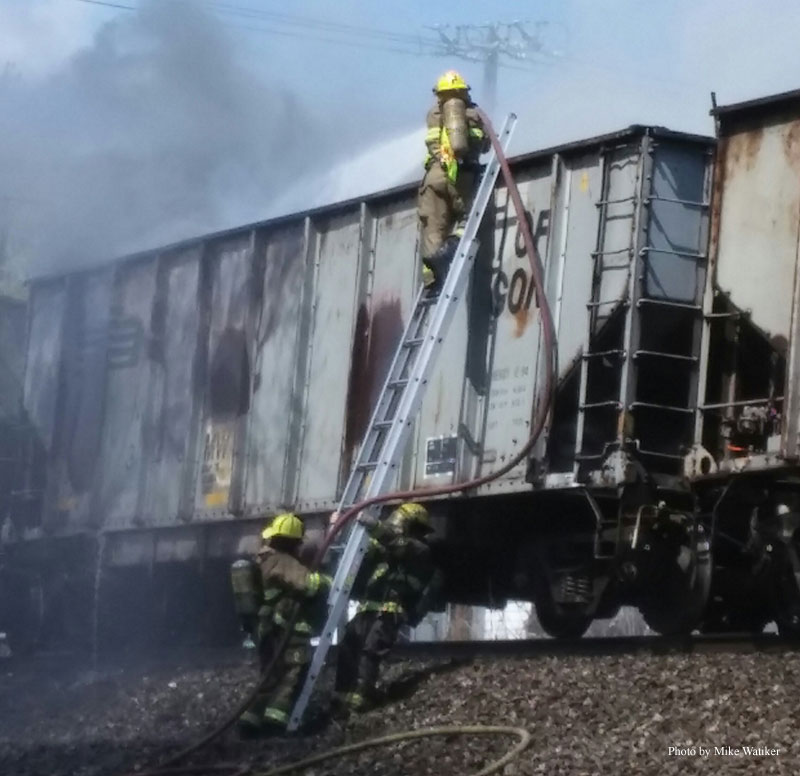 Firefighters attack a train fire.