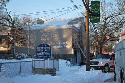 (12) A side view of the building. Note the middle building behind the fire building. There are a lot of apartments in this complex, and accounting for all the occupants is tough.