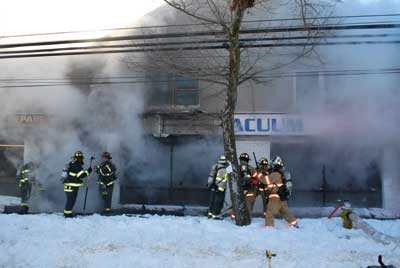 (6) Members get ready to enter the fire store to do a complete secondary search.