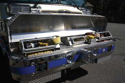 This front bumper extension contains two preconnected hose reels and a cord reel and serves as a mounting location for air horns, siren speakers, and a mechanical siren