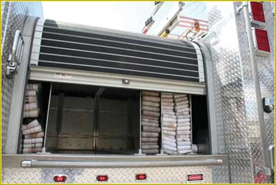 (22) Hard hosebed covers can either be hinged treadplate doors or roll-up slotted material as shown here.