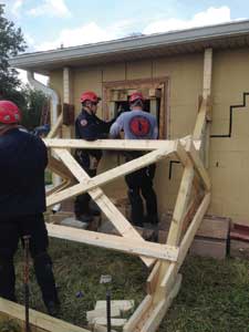 (1) Members of the IDHS District 4 Task Force shoring a damaged house. (Photos by authors)