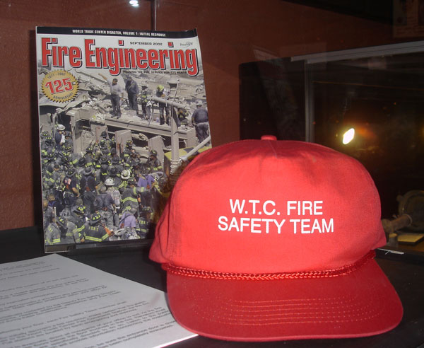 Photo 2: WTC Fire Safety Team (Fire Warden) Hat and Fire Engineering September 2002 cover.