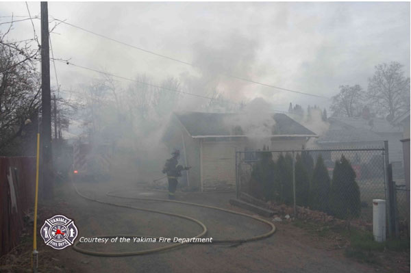 A firefighter operating at any alley fire.