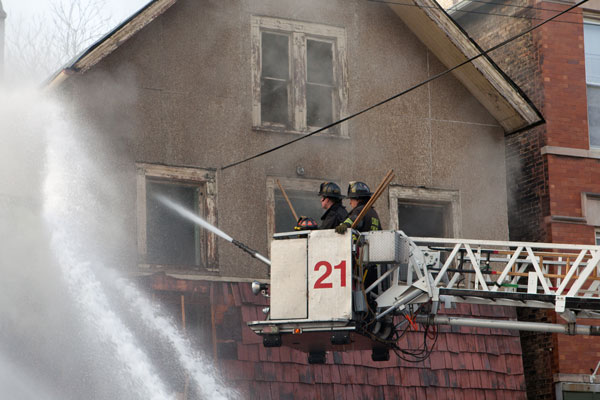 Firefighters in an aerial at fire scene.