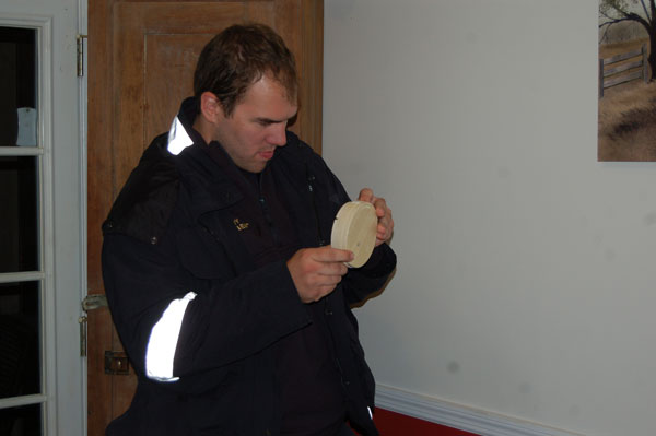 A firefighter examines a smoke alarm.