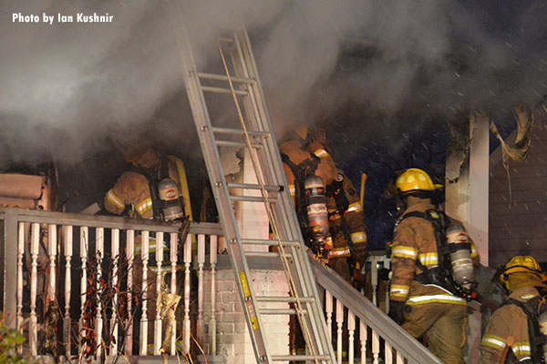 Firefighters operating on a porch during a Melvindale hosue fire.