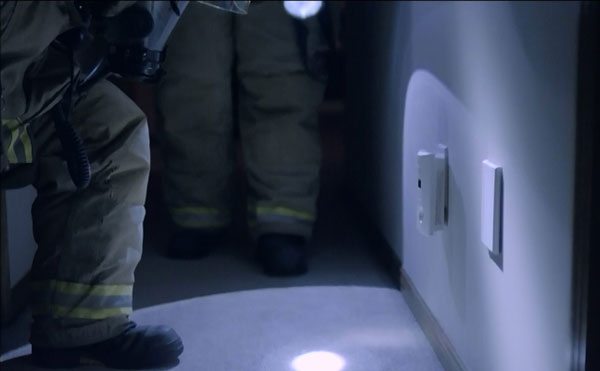 A still from the film showing firefighters and a detector.