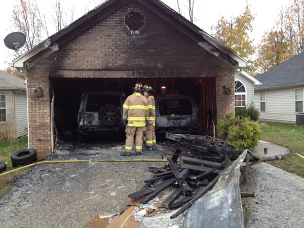 Firefighters outside the garage, post fire.