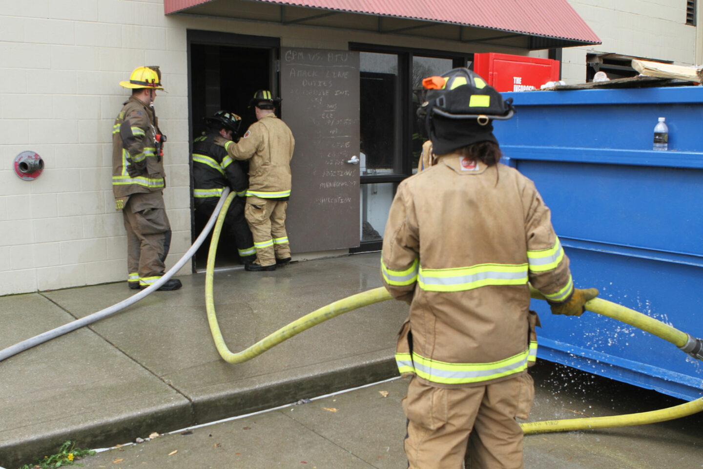 Firefighters managing hoselines