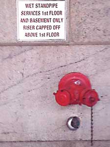 (2) Temporary signage above a FDC connection provides the pump operator with building intelligence as to what floors are active for standpipe operations.