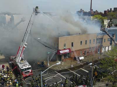 (1) At the four-alarm fire in the Bronx, the original fire building was a 150-year old, three-story balloon-frame (Type V) structure 