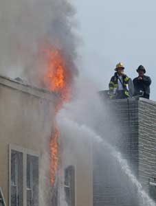 (2) Flames burn vigorously above the roof line of the EIFS-clad structure, causing untenable heat and smoke conditions inside the building.