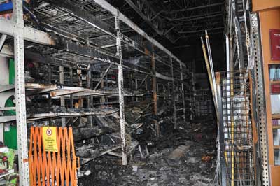 (2-3)The damaged storage racks in the paint department.