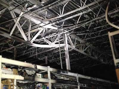 (5-6) One of the girder trusses distorted by the extremely high heat release fire.