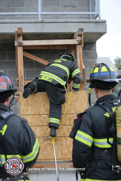 Firefighters practice window entry techniques. Courtesy Yakima Fire Department.