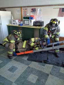 (8) The firefighter at the butt of the ladder should lift with his legs and not his back to avoid an injury. The firefighter at the head should ensure that the victim's helmet, mask, or head does not hit the sill during the removal.