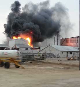 (2) One of the earliest photos of the fire, taken from the southeast side of the plant, showing one of the first unidentified firefighters on scene.