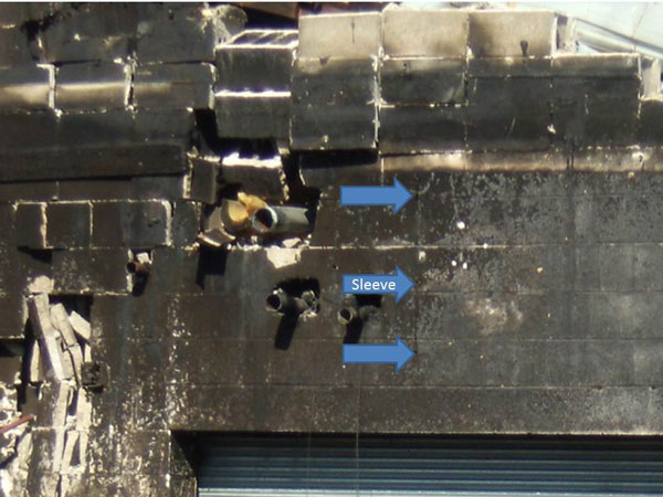 Building construction: A hain and melted fusible link (arrows) on the side of the wall that was first exposed to fire.