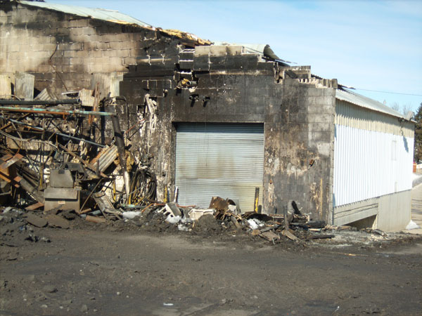 Building Construction: The fire-rated wall and door, which were damaged by the fire and the collapse of that part of the building after the fire was extinguished.