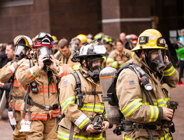 Final adjustments: Firefighters prepare to climb 788 vertical feet in full turnout gear.