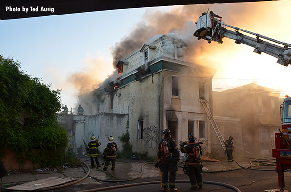 Firefighters at the scene of a dwelling fire in Camden City, New Jersey.