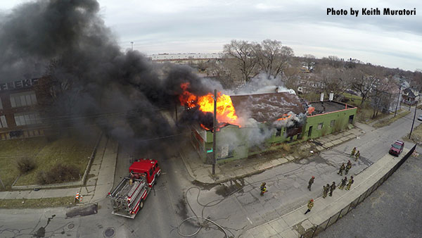 Firefighters and fire apparatus at structure fire, as seen from above by a drone. By Keith Muratori.