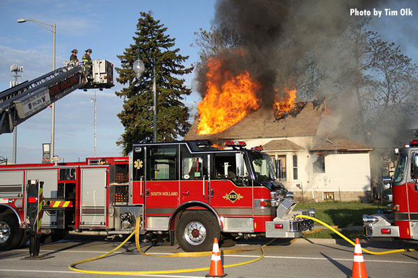 South Holland (IL) fire apparatus during live-fire training at an acquired structure.