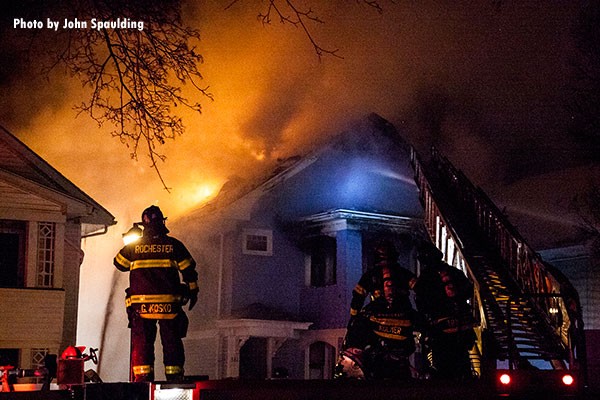 Firefighters at the scene of a house fire in Rochester, New York. Photo by John Spaulding.