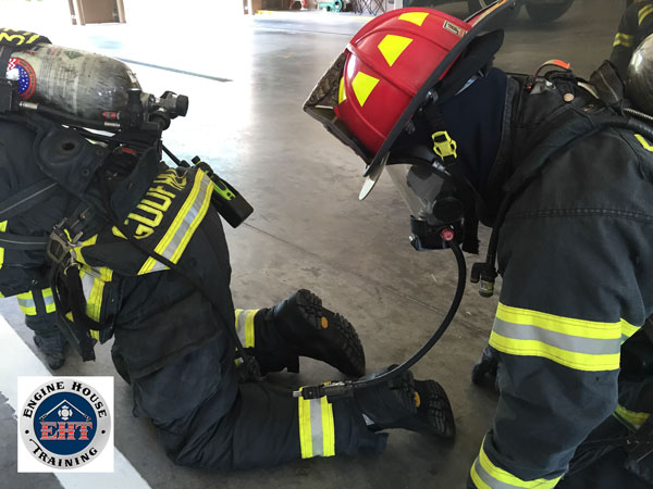 Firefighters training on buddy breathing techniques.