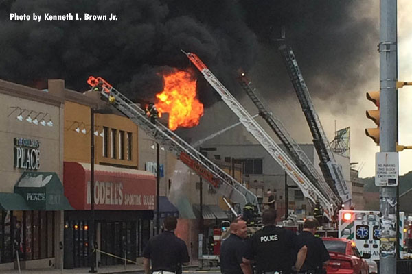 Firefighters conduct aerial operations at a 4-alarm fire in Upper Darby Township, Pennsylvania.